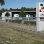 A Sentry Mini-Storage Rv and boat storage facility sign, standing outside showing off the storage units.