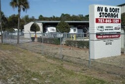 A Sentry Mini-Storage Rv and boat storage facility sign, standing outside showing off the storage units.