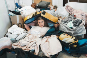 woman in pile of house clutter