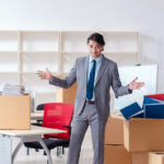 Young business professional packing up important documents to put into a self-storage unit.