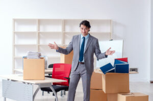 Young business professional packing up important documents to put into a self-storage unit.