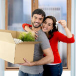 happy couple moving and downsizing into a smaller home