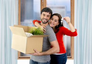 happy couple moving and downsizing into a smaller home