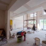 Interior of construction site with scaffolding in a large modern unfinished duplex apartment
