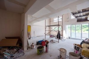 Interior of construction site with scaffolding in a large modern unfinished duplex apartment